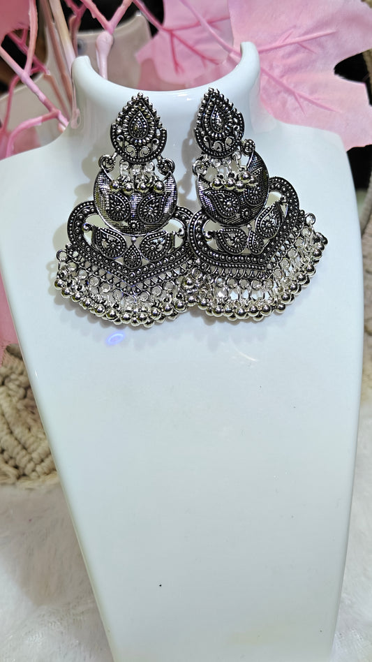 intricately crafted oxidized silver earrings,shimmering with detailed patterns and dangling silver beads at Dilverse